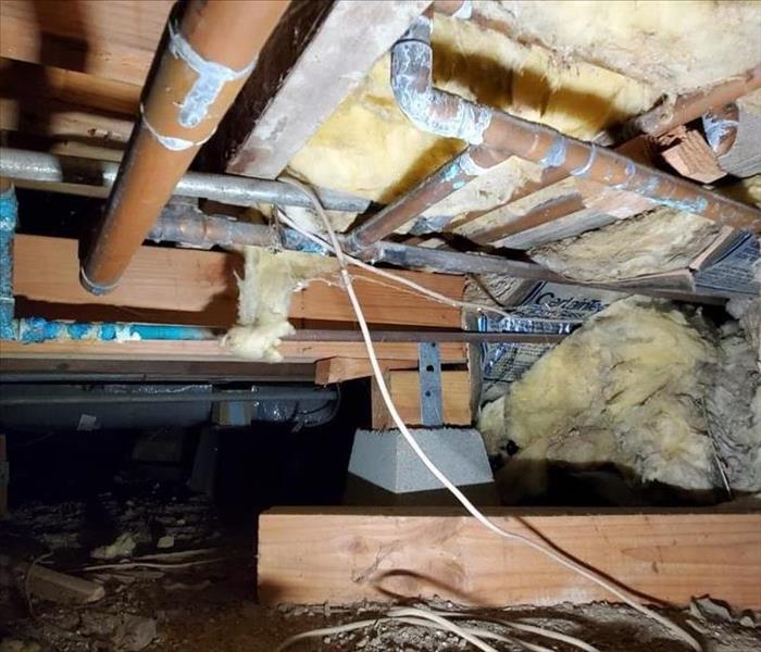 Crawlspace with mold and insulation falling